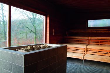 Innenansicht einer Saunakabine im Molzbergbad mit Panoramafenster in die Natur.